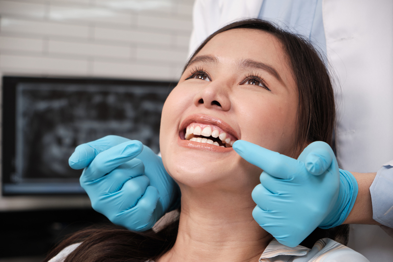 A dentist examining a patient's teeth